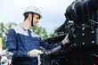 © Parilov - Mechanic with tablet computer diagnostics of diesel engine from industrial truck in garage. Fix service repair industry lorry concept