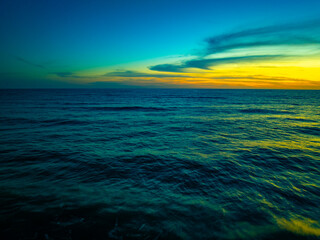 Wall Mural - Aerial view Beautiful view sunset over sea surface beautiful wave Amazing light sunset or sunrise sky over sea beach with wave crashing in the ocean.nature background