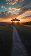 © JohnnyMohAzar - a breathtaking sunset with a circular structure on a grassy hill