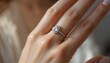 © ddaremmth - Elegant hand wearing an oval diamond ring under soft lighting, the gemstone shining with brilliance and luxury.