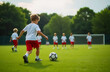 © Родион Бондаренко - little boy playing football on the field with his friends in the background