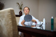 © Taras Grebinets - Woman Applying Skincare at Home with a Makeup Mirror on Table