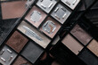 © New Africa - Different used eyeshadow palettes as background, closeup