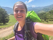 © Юлия Завалишина - Hiking tourism adventure. Backpacker hiker woman taking selfie picture. Hiker girl lady tourist with backpack walking near mountain. Young happy woman enjoy hike trekking tourism active vacation