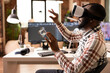 © DC Studio - Black male engineer wearing VR headset gesturing hands in 3D simulation, analyzing designed clamp model. Immersive technology enables interactive engineering review and detailed product inspection.