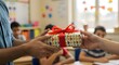 © amera - A teacher and student exchanging a colorful present wrapped with a vibrant red ribbon at the classroom.