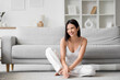 © Pixel-Shot - Beautiful young woman with short brown hair at home