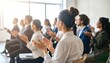© hendar - A diverse group of businesspeople applauding in a conference room