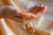 © Aleksandr - Close-up of caucasian female hands with golden liquid dripping in warm light