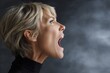 © Aleksandr - Female caucasian mature profile yelling in anger against gray background
