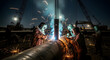 © Dev - Welders at Work Sparks Flying During Pipeline Construction at Night.
