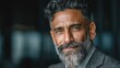 © SaroStock - Portrait of a confident mature man with gray hair in Suit, staring intently with a slight smile at the viewer, showing experience and wisdom