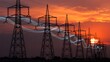 © Emongrapic - Towering electricity pylons silhouetted against a dramatic sunset sky