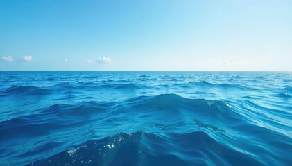 Wall Mural - Vast expanse of deep blue ocean water, waves gently rolling under a clear sky Perfect for travel, nature, and environmental themes , conservation, light, ecology