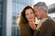 © Iryna - Caucasian mature couple embracing outdoors in urban setting