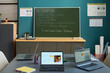 © pressmaster - Classroom scene showing empty desks with open laptops in foreground, green chalkboard with AI prompting instructions written in chalk, educational posters on blue wall in background