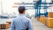 © Johnnii - A port security officer stands on a dock, overseeing shipping containers and cranes in the background, promoting safety and efficiency in maritime operations.
