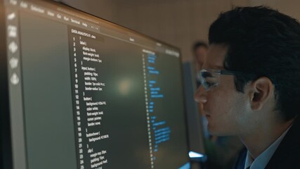 Professional businessman developing artificial intelligence code on computer in contemporary office environment, showing data strategy teamwork and corporate technology for digital future growth