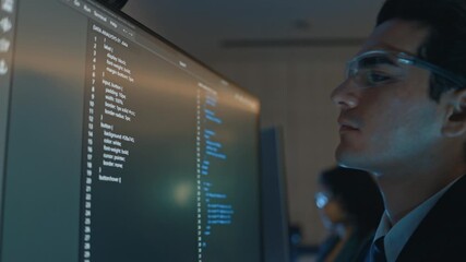 Professional businessman developing artificial intelligence code on computer in contemporary office environment, showing data strategy teamwork and corporate technology for digital future growth