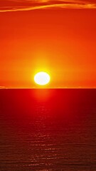 Wall Mural - Vertical view of sunrise from sea horizon. Timelapse.