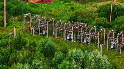 Wall Mural - Drone featuring high voltage electrical substation surrounded in greenery.