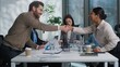 © Yuliia - Caucasian business woman team leader showing graph chart talking briefing two multiethnic businesspeople shake hands handshaking gesture men women diverse coworkers in office agreement deal cooperate