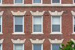 Classic red brick facade with orderly windows revealing timeless urban residential architecture in Cambridge, Massachusetts, USA
