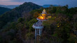 Aerial view of scenery Khao Rang viewpoint at twilight.
view of a town nestled among lush green mountains at sunset, with a Pavilion structure perched on the hillside at Phuket town at Dusk