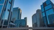 © KM - Stunning architectural landscape of modern glass skyscrapers reflecting the clear blue sky in the urban cityscape