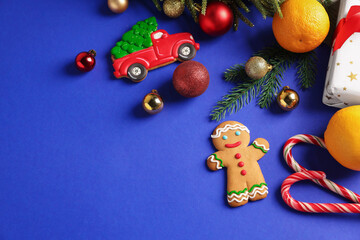Wall Mural - Saint Nicholas day. Fir branches, ornaments and treats on blue background, flat lay. Space for text