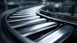 © Tahsin - A close up view of a metal conveyor belt with rollers in a factory setting