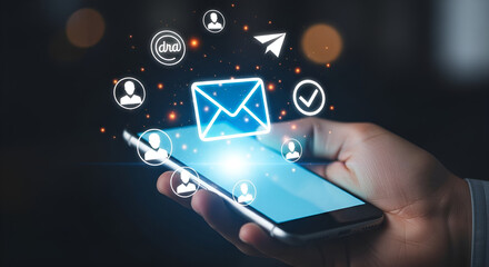 Hand holding smartphone with email icon, communication and social media