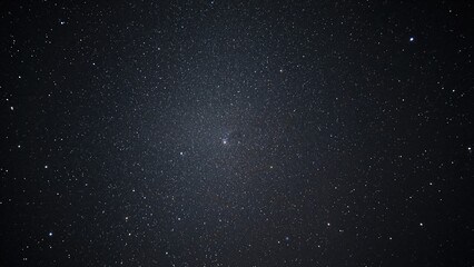 Wall Mural - Wide-angle view of the Milky Way galaxy under a pitch-black sky. Deep space captured with noise and grain effects. Long exposure photography with adjusted white balance.