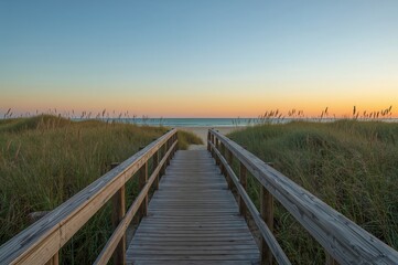 Wall Mural - Timber trail stretching toward a sandy shore with dunes under a sunset sky