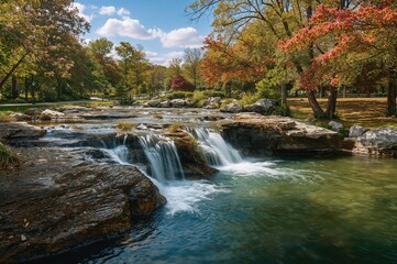 Wall Mural - water streaming down rocky ledges in a tiered waterfall. stroll through the garden.