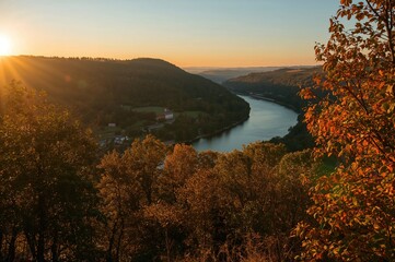 Wall Mural - Scenic river valley illuminated by the warm glow of a late autumn afternoon.