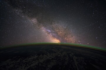 Wall Mural - A cosmic view capturing the Milky Way along with Earth's atmosphere and auroras, created using elements provided by a space agency.
