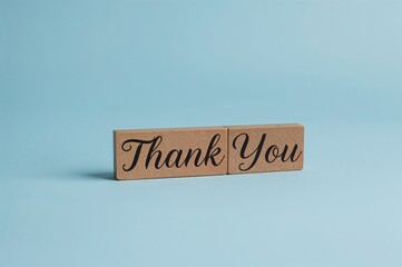 Wall Mural - Wooden blocks spelling 'Thank you' arranged on a blue surface