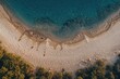 © vxnaghiyev - Overhead perspective of a sandy spit protected by a barrier at dusk. Aerial shot of a white beach meeting clear blue waters. Coastal scenery with transparent turquoise sea. Natural landscape seen