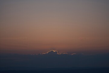 Wall Mural - sunset sky glowing with sunshine and clouds, vibrant twilight scenery.