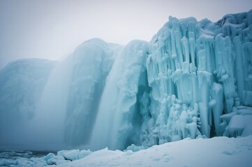Wall Mural - Ice-covered waterfall displaying shades of blue and white