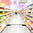 © Yusuf - Supermarket aisle with shopping cart, blurry background