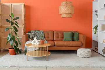 Wall Mural - Interior of stylish living room with brown sofa, shelf unit and folding screen