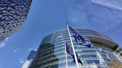 Wall Mural - EU flags waving in front of the Lex Building glass facade in Brussels
