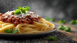 © Yurii Semonov - Spaghetti bolognese with parmesan and parsley on marble podium with neutral background
