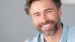© Matcha_09 - Closeup of man smiling broadly with genuine happiness, showcasing his well groomed beard and bright blue eyes. soft background enhances warm and inviting atmosphere