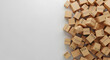 © Pixel By Bi - Numerous small cardboard boxes scattered on a plain white surface, creating a visual texture.