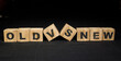 © pexelsstock - Old vs new text concept on a wooden cube, on a black background