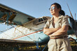 © Cavan - Confident woman by old plane