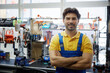 © Nomad_Soul - Man worker in work clothes stands with arms crossed in workshop